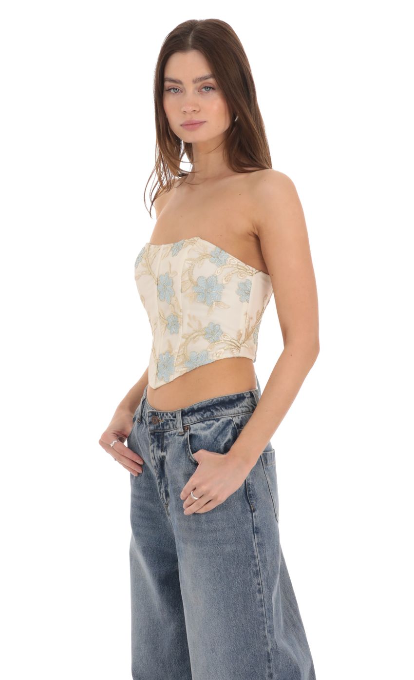 Picture Floral Embroidered Corset Top on Cream. Source: https://media-img.lucyinthesky.com/data/Feb24/850xAUTO/5985d228-1777-40b2-bed4-2b2a887957b9.jpg