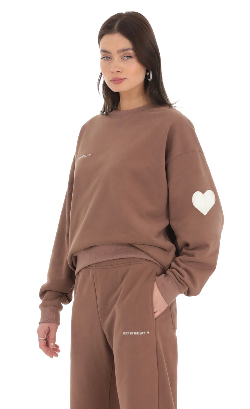 Picture Embroidered Lucy in the Sky Jumper in Brown. Source: https://media-img.lucyinthesky.com/data/Feb24/850xAUTO/8869c446-7685-4386-8673-17479052e153.jpg