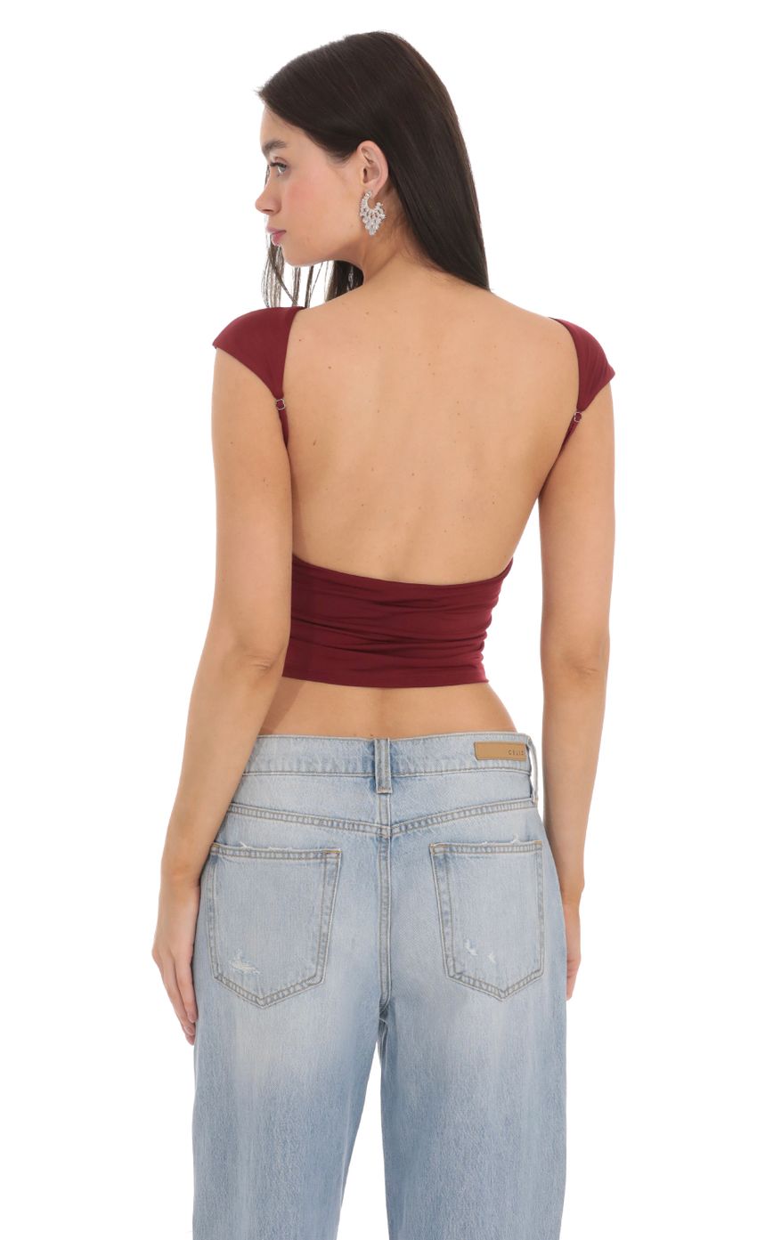 Picture High Neck Open Back Top in Maroon. Source: https://media-img.lucyinthesky.com/data/Feb24/850xAUTO/898cd572-d733-41b9-819c-e926b523318f.jpg
