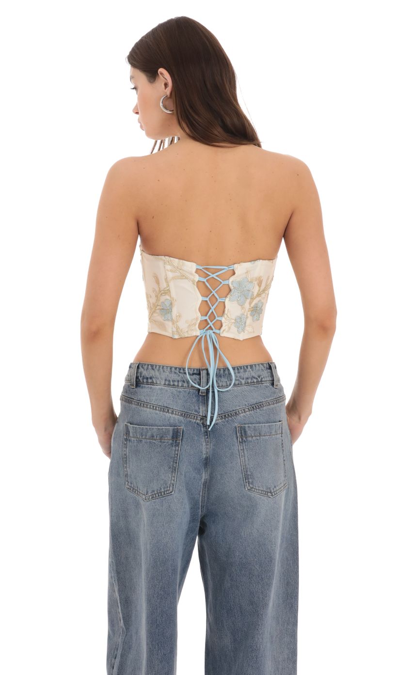 Picture Floral Embroidered Corset Top on Cream. Source: https://media-img.lucyinthesky.com/data/Feb24/850xAUTO/8c51f69d-4d4a-4676-8866-0c8d055067cf.jpg