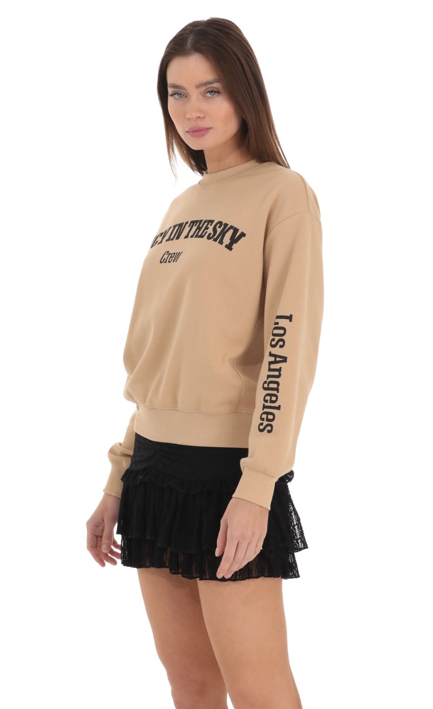 Picture Lucy in the Sky Crew Jumper in Brown. Source: https://media-img.lucyinthesky.com/data/Feb24/850xAUTO/b117a754-7f1b-4b54-b501-aba93c2e034a.jpg