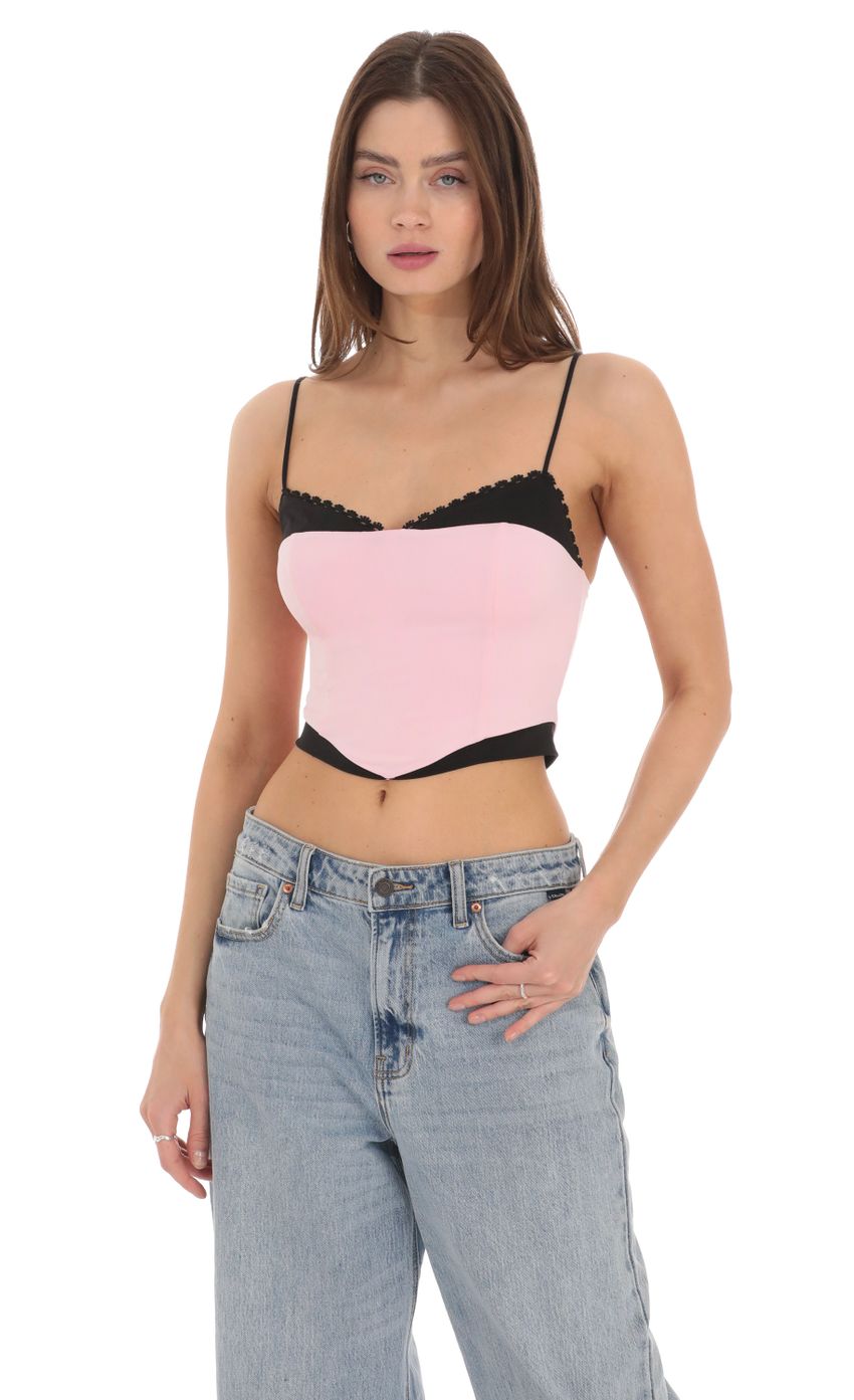 Picture Black Trim Crop Top in Pink. Source: https://media-img.lucyinthesky.com/data/Feb24/850xAUTO/bcd33f31-767f-4511-8303-6aa6df5e1407.jpg