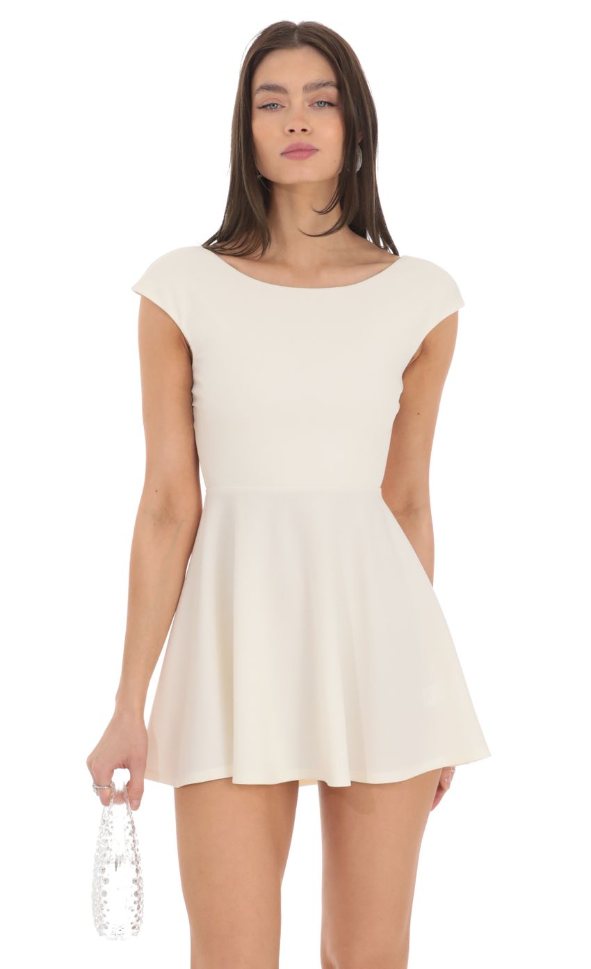 Picture Short Sleeve Open Back A-line Dress in Ivory. Source: https://media-img.lucyinthesky.com/data/Feb24/850xAUTO/ddb9ac06-9d29-4f8b-a1ca-aaeceb230542.jpg