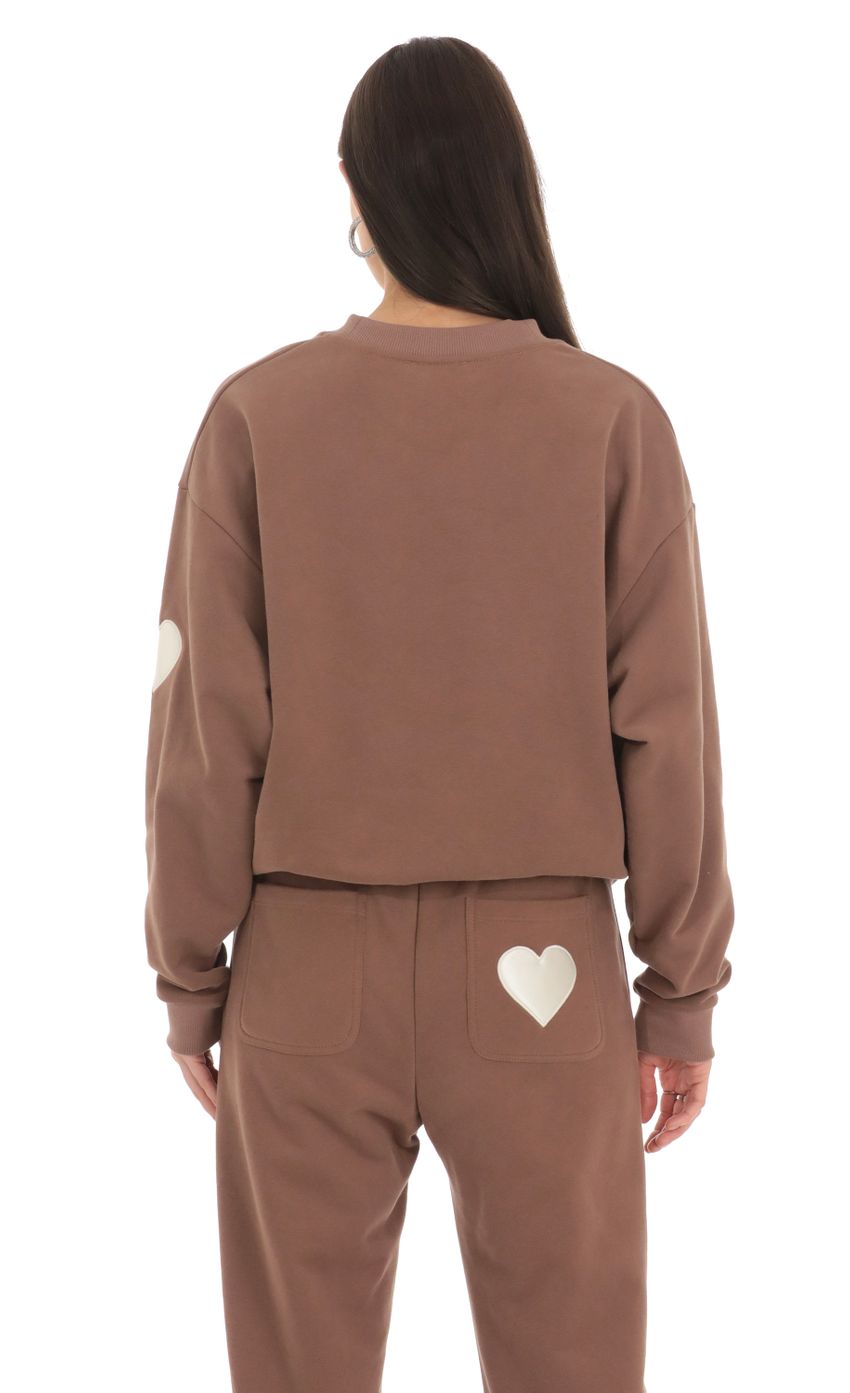Picture Embroidered Lucy in the Sky Jumper in Brown. Source: https://media-img.lucyinthesky.com/data/Feb24/850xAUTO/df4572bf-ca20-4787-8edd-721083c8f680.jpg
