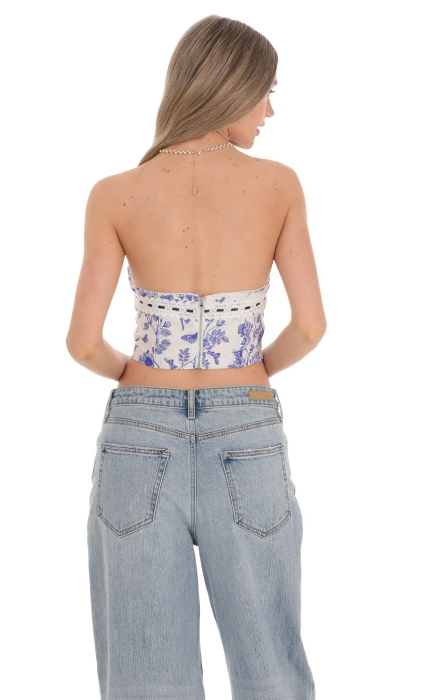 Picture Blue Floral Corset Top in White. Source: https://media-img.lucyinthesky.com/data/Feb24/850xAUTO/e2c1cd12-a29a-4cc4-a8e0-db3cb15af2dd.jpg