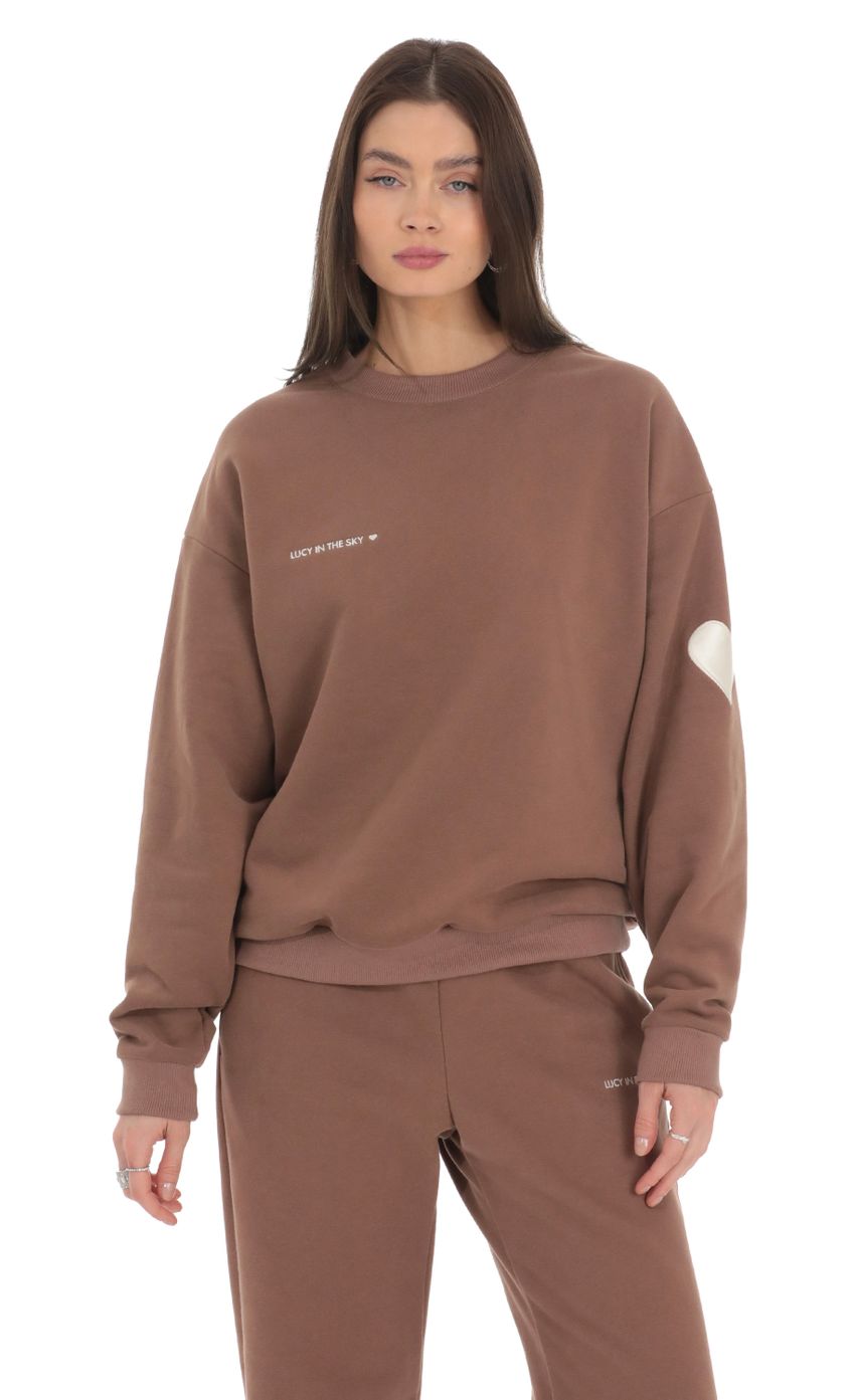 Picture Embroidered Lucy in the Sky Jumper in Brown. Source: https://media-img.lucyinthesky.com/data/Feb24/850xAUTO/f3e56472-4a5b-4a48-9bce-d10c2fcc349e.jpg