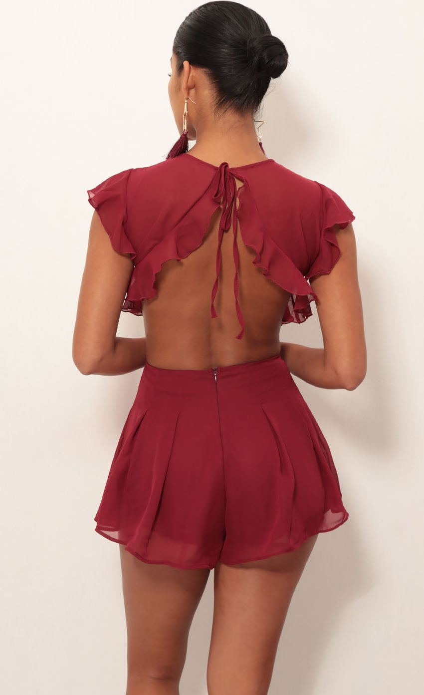 Picture Kara Cutout Romper in Maroon. Source: https://media-img.lucyinthesky.com/data/Jan19_2/850xAUTO/0Y5A2950S.JPG