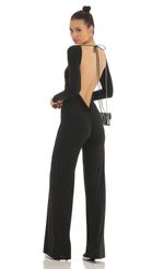 Picture Open Back Long Sleeve Jumpsuit in Black. Source: https://media-img.lucyinthesky.com/data/Jan23/150xAUTO/e1ff380a-94db-45ad-8b1e-913b16e51e85.jpg
