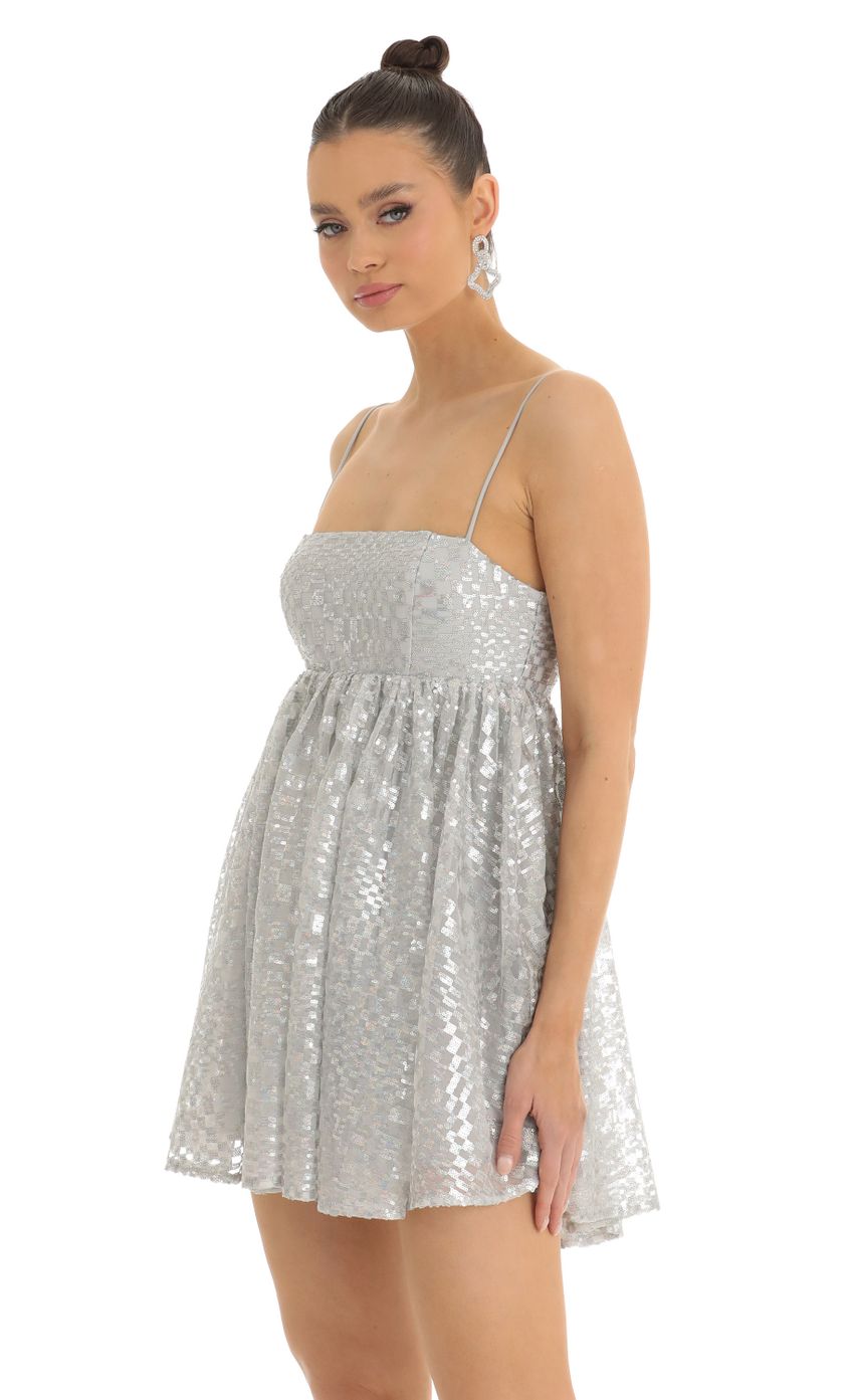 Picture Checkered Sequin Baby Doll Dress in Silver. Source: https://media-img.lucyinthesky.com/data/Jan23/850xAUTO/00e1e270-b5b5-47b6-a6cb-1d3caf2d46d2.jpg