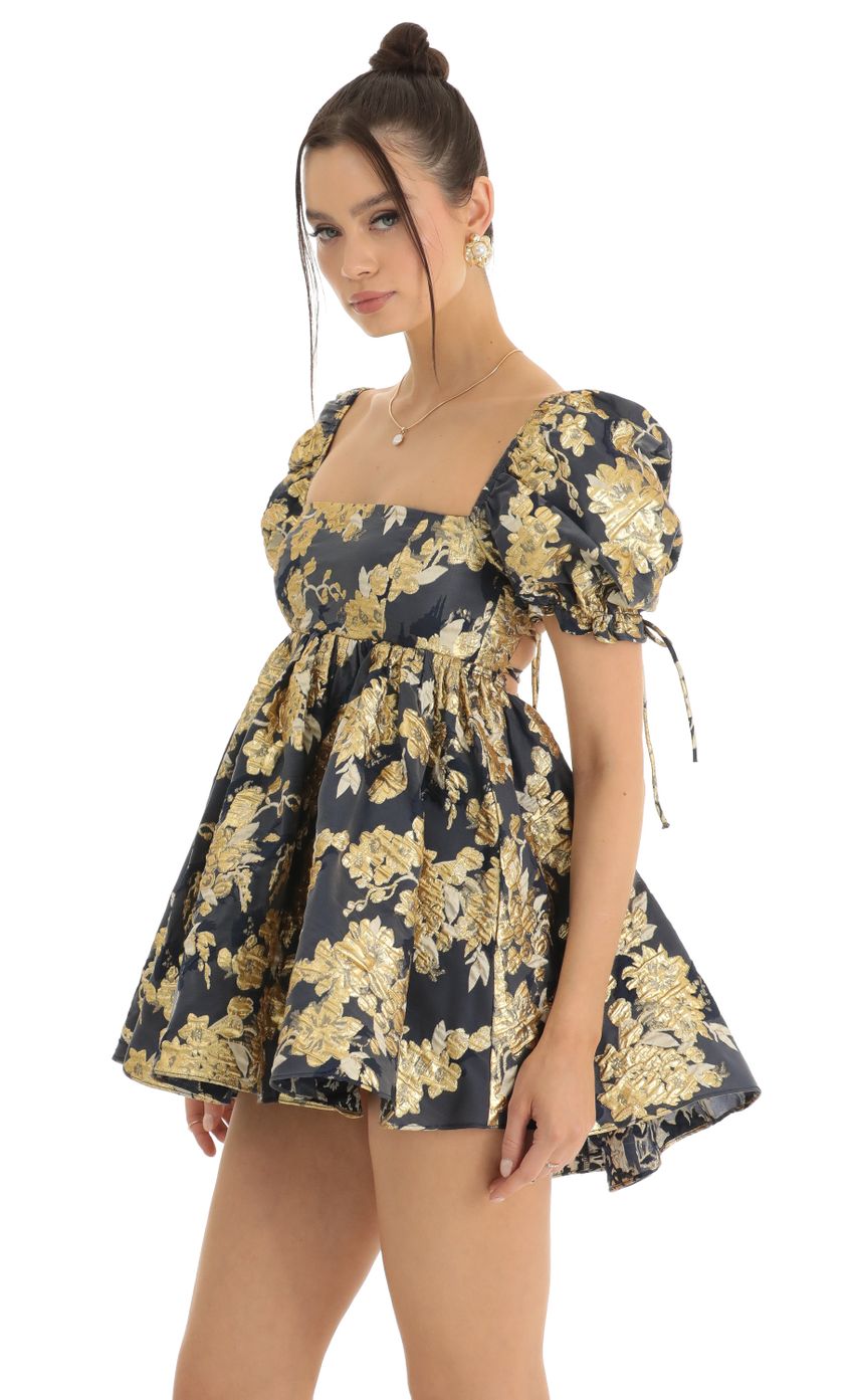 Picture Cheri Gold Floral Jacquard Baby Dolly Dress in Navy. Source: https://media-img.lucyinthesky.com/data/Jan23/850xAUTO/05385ea2-1888-4b1d-a3bf-038501a059e9.jpg