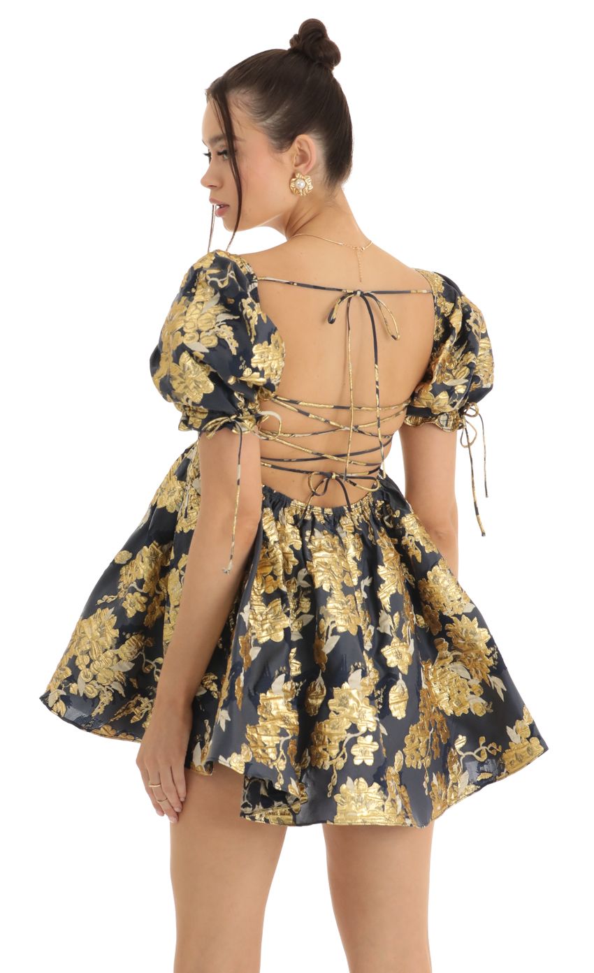 Picture Cheri Gold Floral Jacquard Baby Dolly Dress in Navy. Source: https://media-img.lucyinthesky.com/data/Jan23/850xAUTO/1d6168ab-c910-49fd-8461-e0ba77e45067.jpg