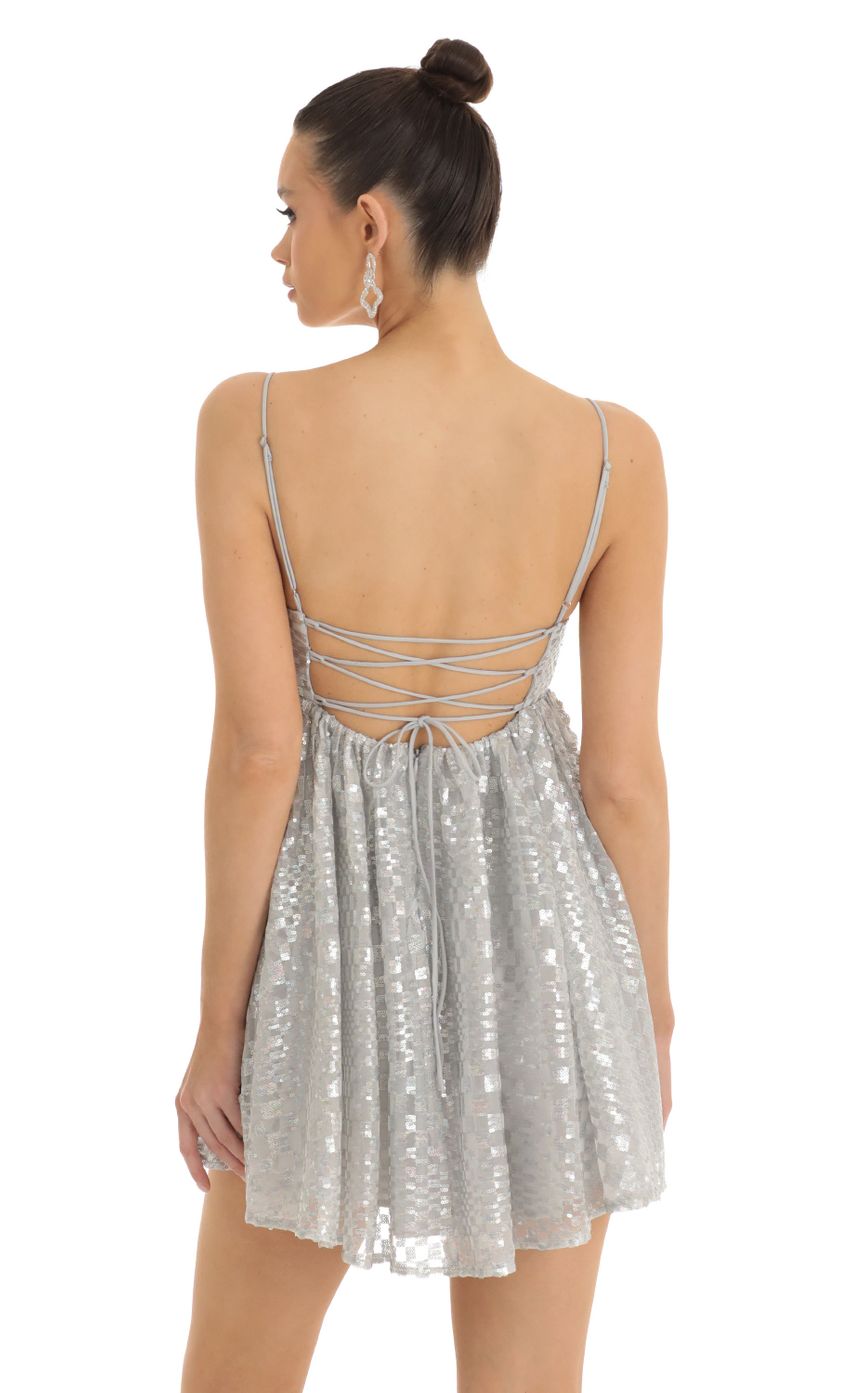 Picture Checkered Sequin Baby Doll Dress in Silver. Source: https://media-img.lucyinthesky.com/data/Jan23/850xAUTO/ac303971-48a9-40ce-947c-985b3f803bfe.jpg