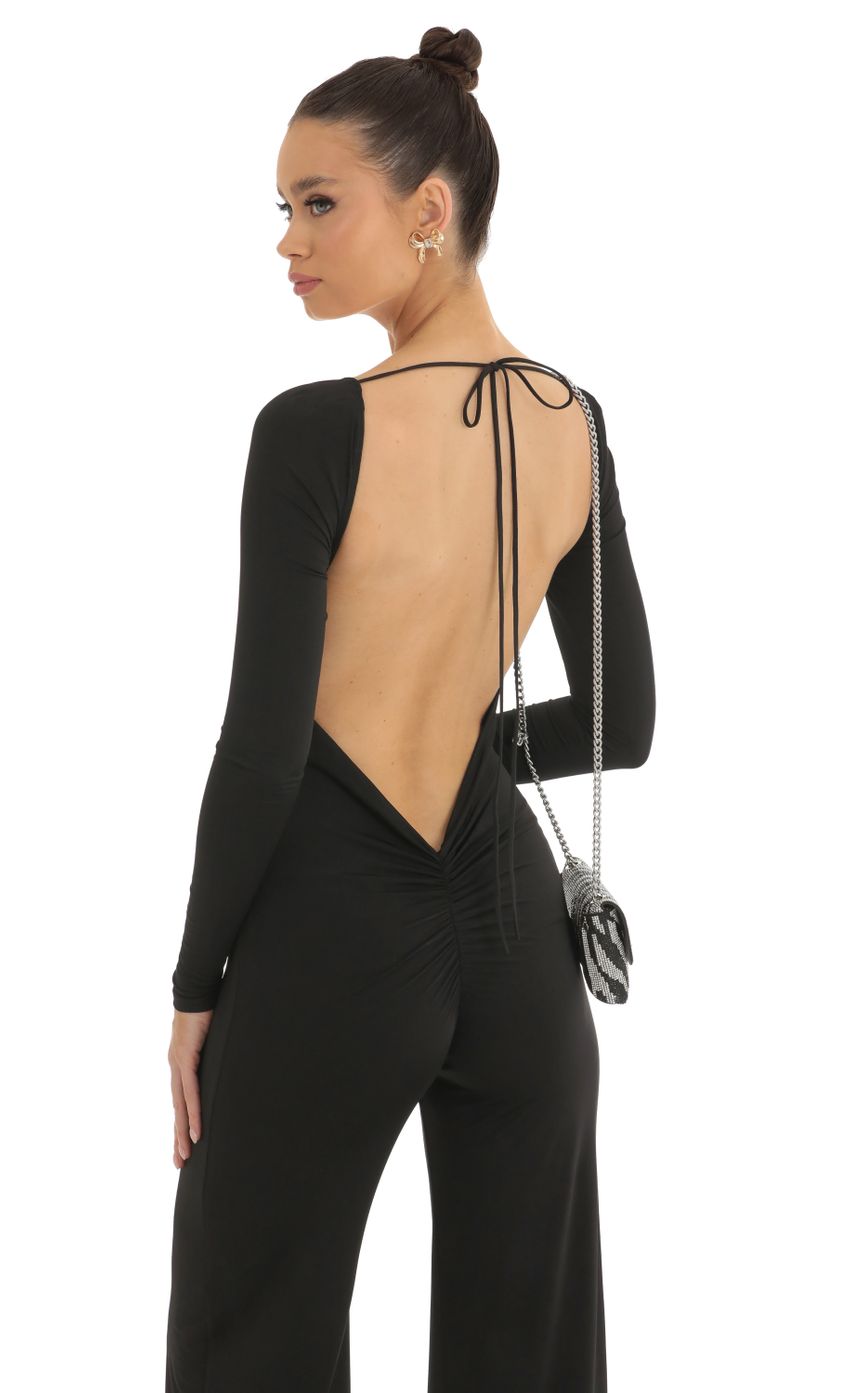 Picture Open Back Long Sleeve Jumpsuit in Black. Source: https://media-img.lucyinthesky.com/data/Jan23/850xAUTO/b644800b-238e-477d-8918-a5c7ba498499.jpg
