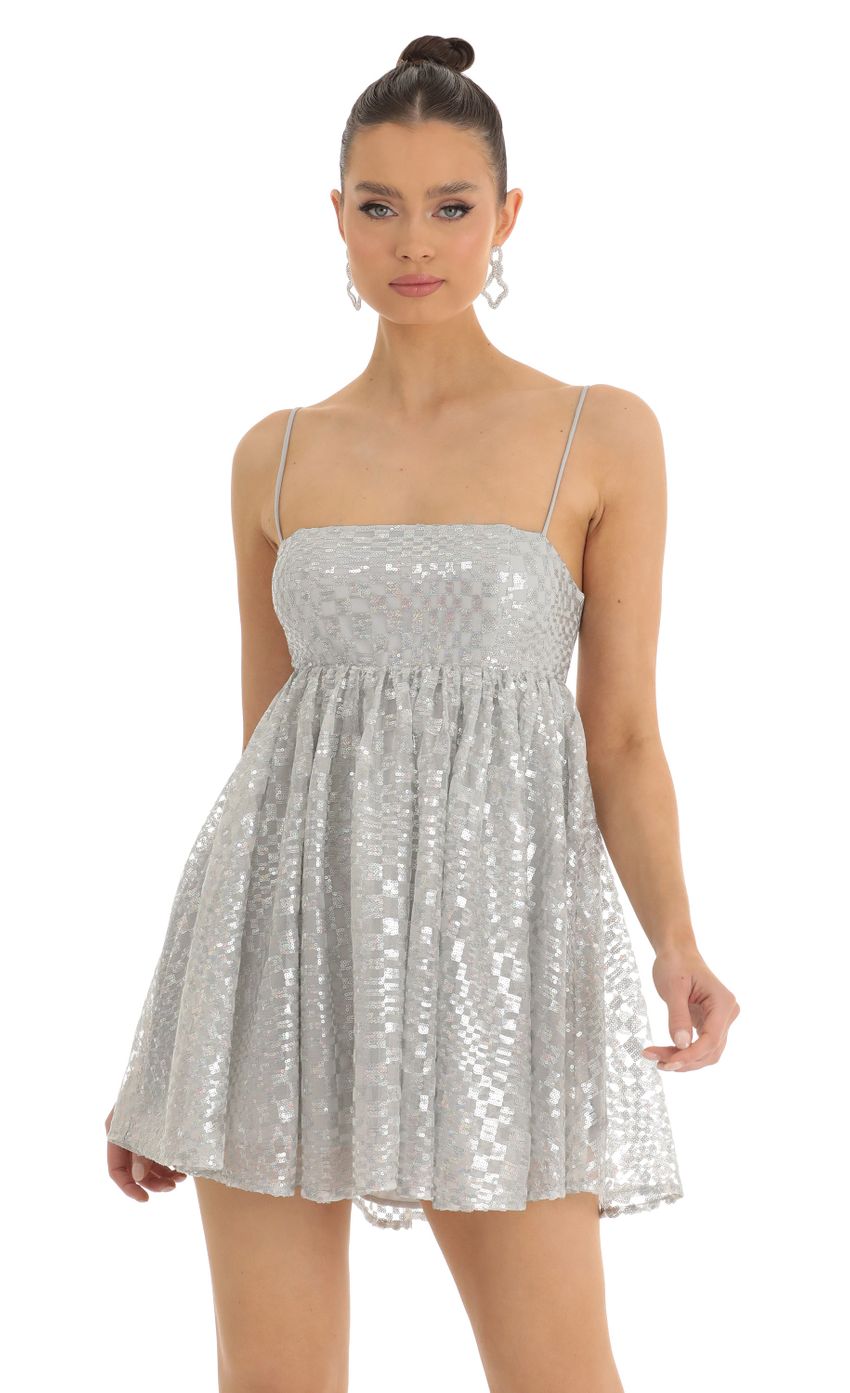 Picture Checkered Sequin Baby Doll Dress in Silver. Source: https://media-img.lucyinthesky.com/data/Jan23/850xAUTO/ca3b5996-b4ec-4411-aaf1-1e38d429ffdd.jpg