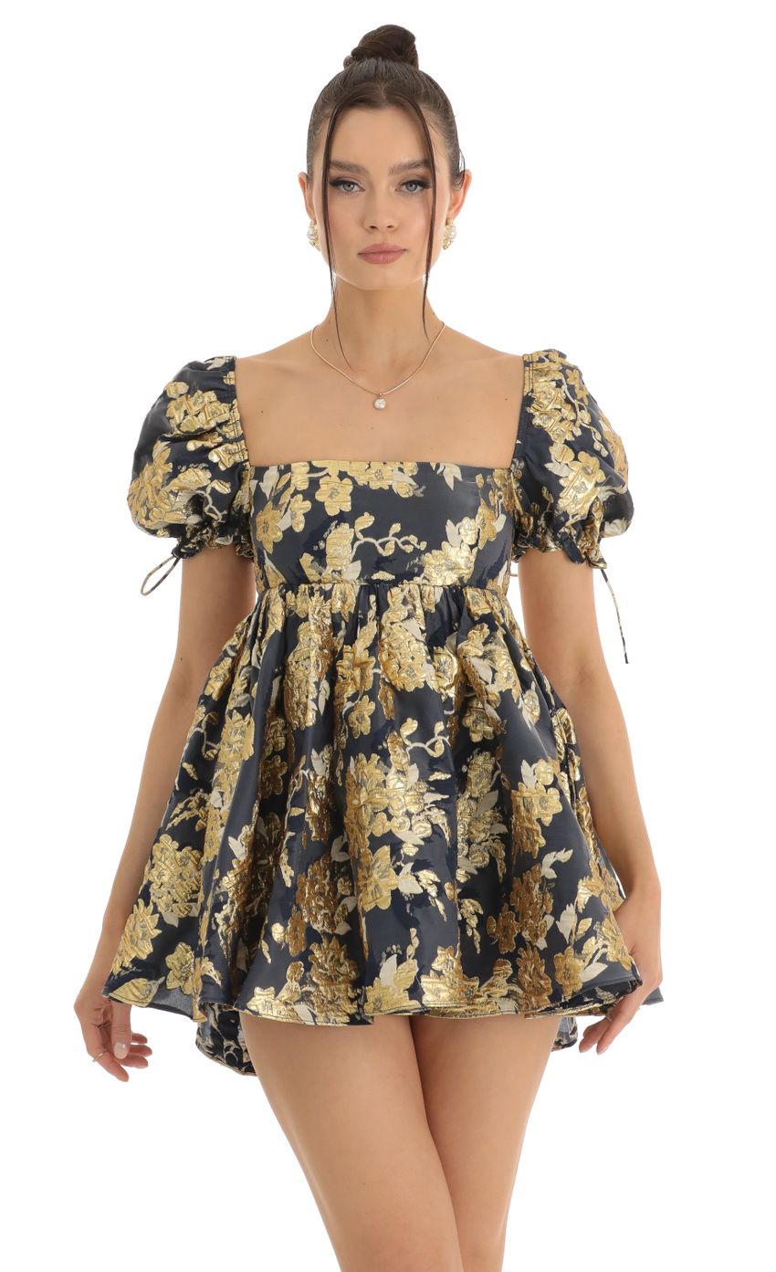 Picture Cheri Gold Floral Jacquard Baby Dolly Dress in Navy. Source: https://media-img.lucyinthesky.com/data/Jan23/850xAUTO/dd6a65c8-8ebe-4658-b9db-dbe3689ceb9f.jpg