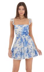 Picture Blue Floral Fit and Flare Dress in White. Source: https://media-img.lucyinthesky.com/data/Jan24/150xAUTO/e61b778a-ed55-4ff8-8c0a-1d737fa4d6ef.jpg