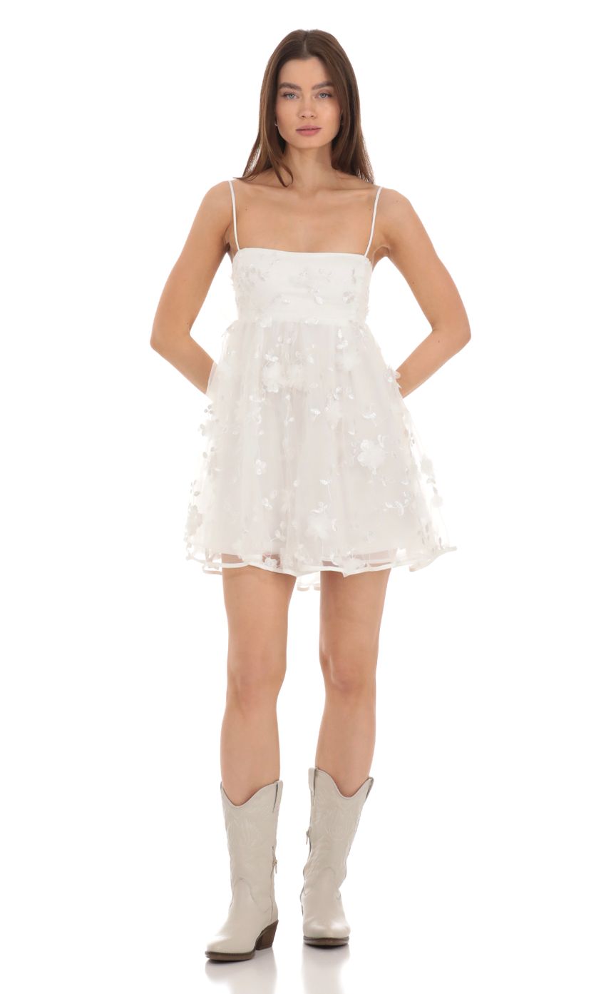 Picture 3-D Foral Babydoll Dress in White. Source: https://media-img.lucyinthesky.com/data/Jan24/850xAUTO/06a3a4bb-c1eb-4498-a77b-a3c6dc09d4f8.jpg