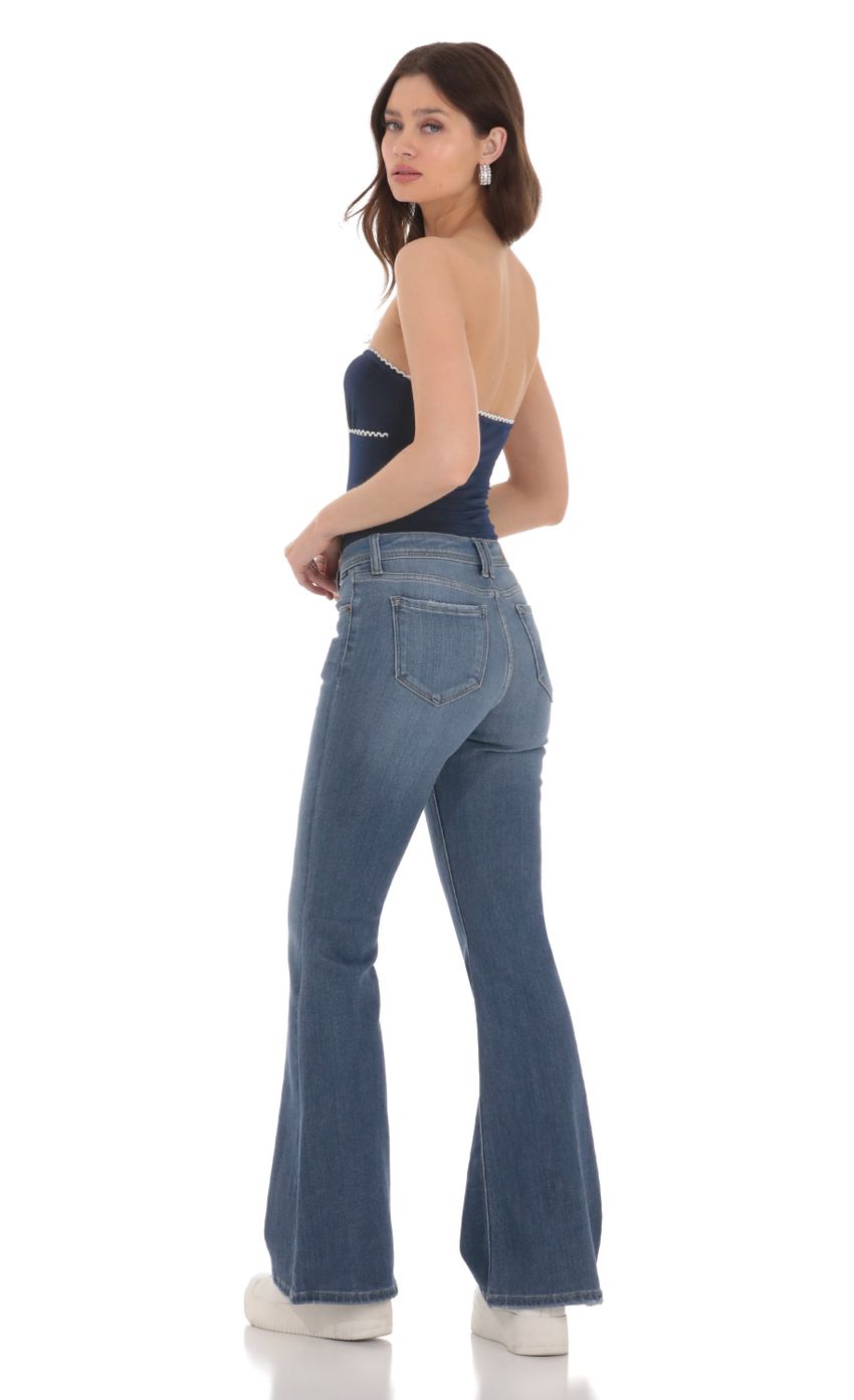 Picture Faded Flare Jeans in Denim. Source: https://media-img.lucyinthesky.com/data/Jan24/850xAUTO/07e29af5-64c4-498d-9659-6d526f56e05e.jpg