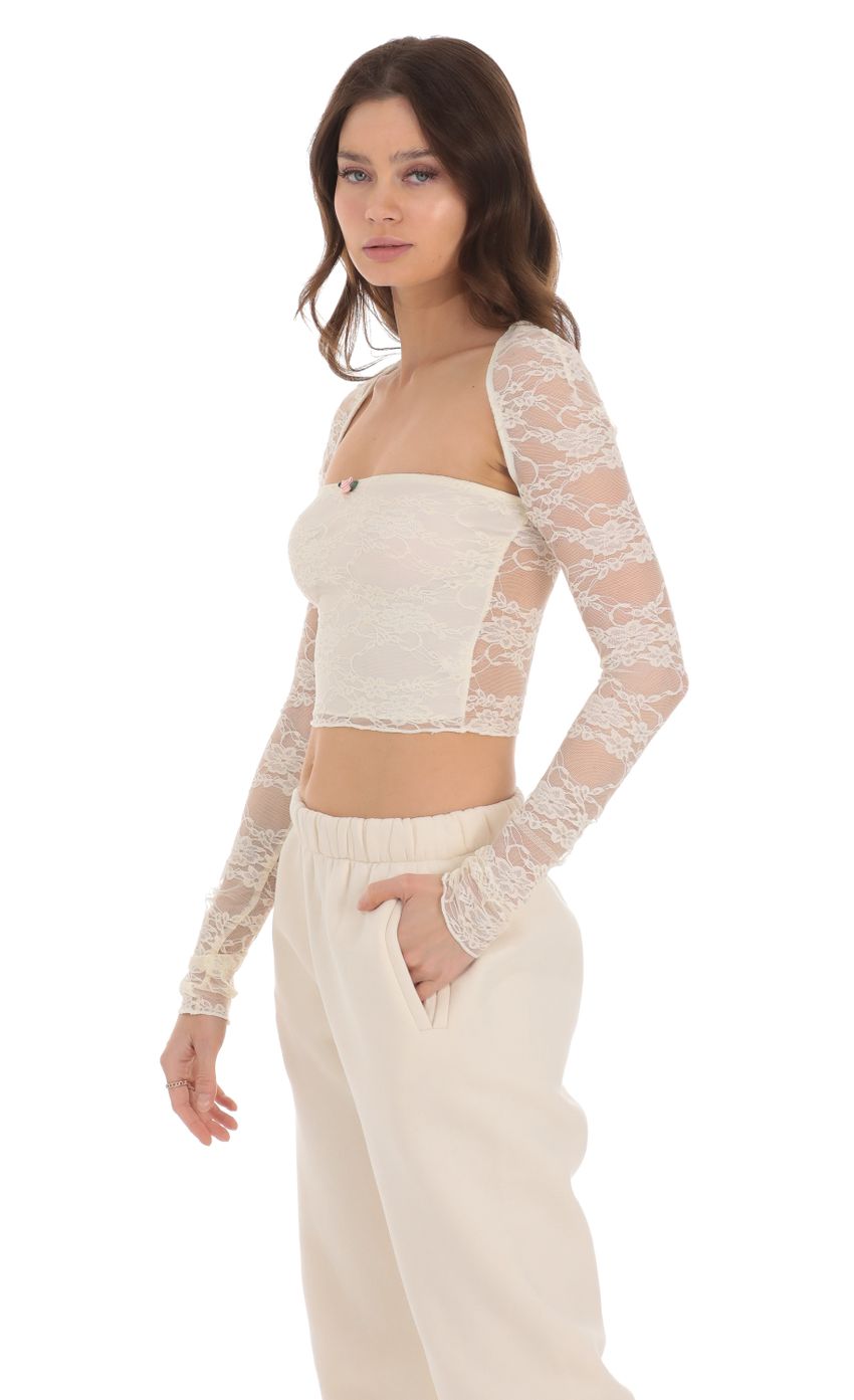 Picture Lace Long Sleeve Top in Cream. Source: https://media-img.lucyinthesky.com/data/Jan24/850xAUTO/0aae3758-47a3-4e45-8e75-62f1bbe9a96d.jpg