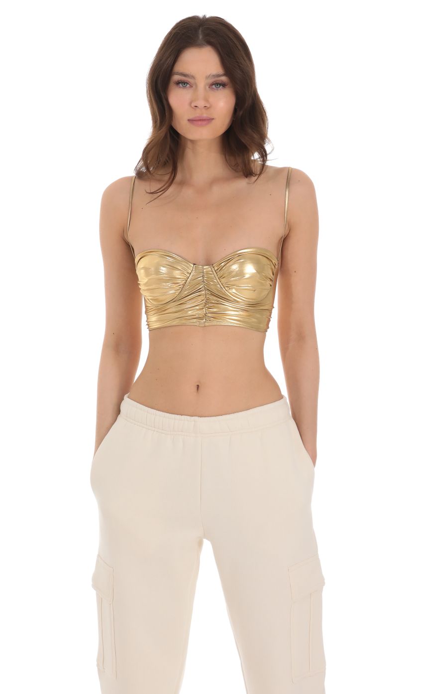 Picture Metallic Ruched Top in Gold. Source: https://media-img.lucyinthesky.com/data/Jan24/850xAUTO/2c5ebc41-9cac-406c-a272-6daace808c8e.jpg