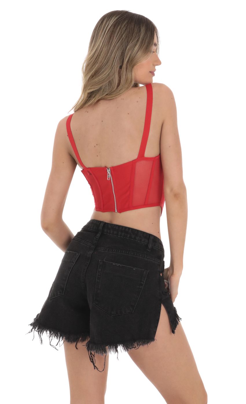 Picture Mesh Corset Top in Red. Source: https://media-img.lucyinthesky.com/data/Jan24/850xAUTO/3e5683bd-fffe-47dc-935f-f6c44dfc5caa.jpg