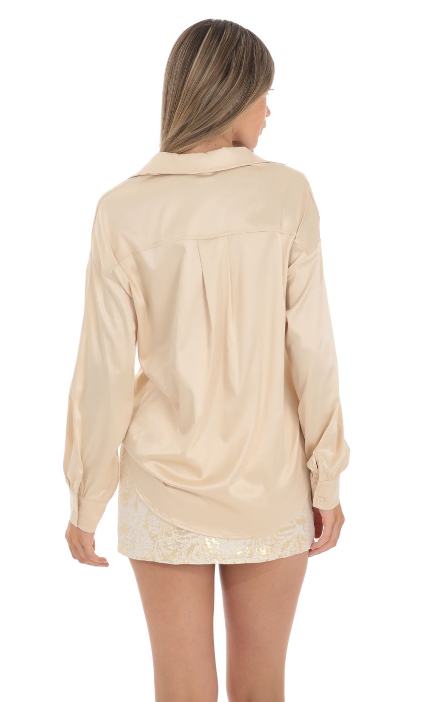 Picture Satin Button Down Top in Champagne. Source: https://media-img.lucyinthesky.com/data/Jan24/850xAUTO/4a95b7be-4614-4408-8573-db921f72a558.jpg