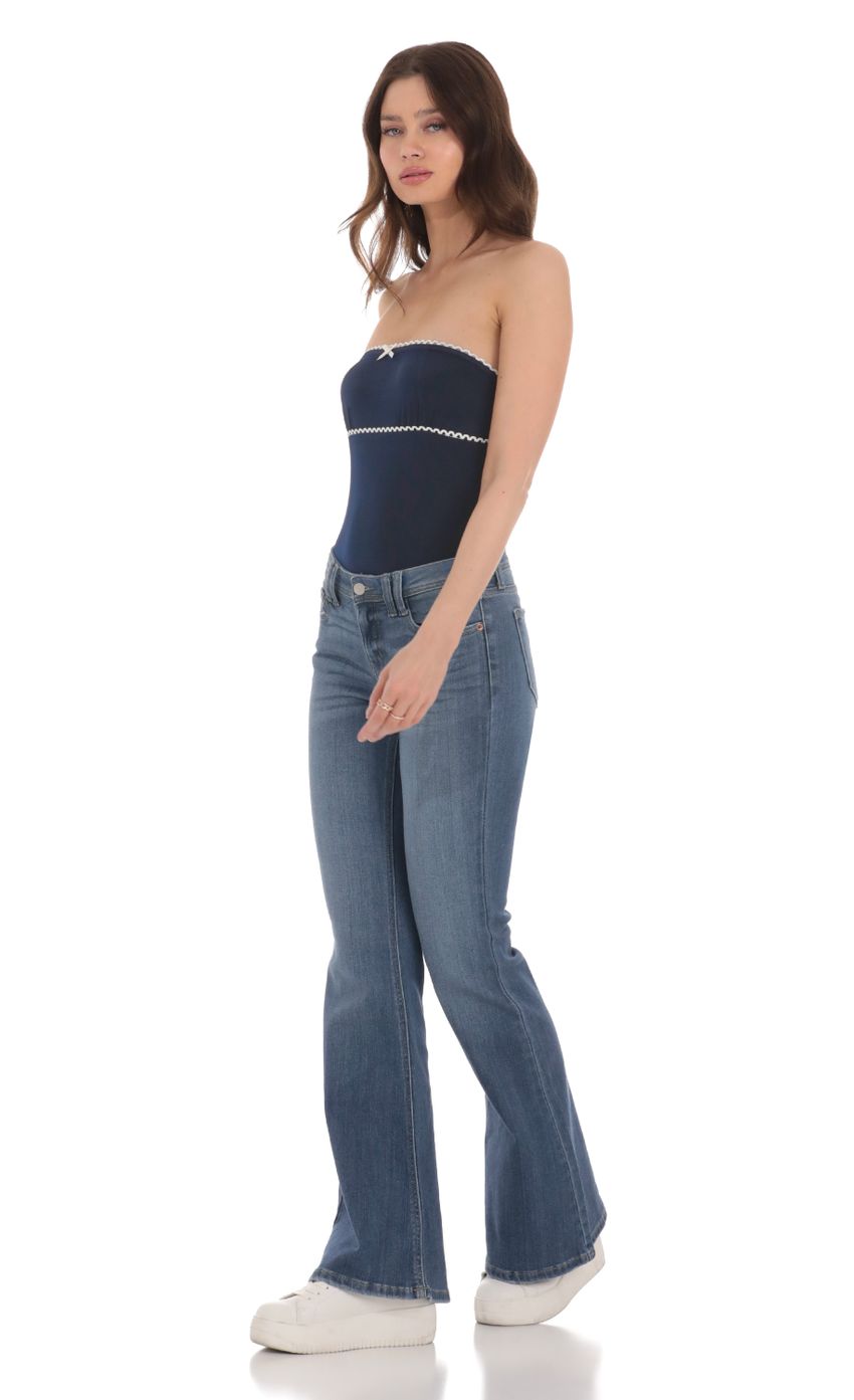 Picture Faded Flare Jeans in Denim. Source: https://media-img.lucyinthesky.com/data/Jan24/850xAUTO/80a7c3e0-92fd-472b-95cc-046168802a88.jpg