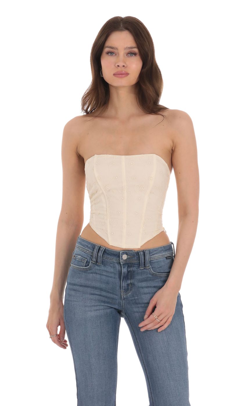Picture Floral Embroidered Corset Top in Vanilla. Source: https://media-img.lucyinthesky.com/data/Jan24/850xAUTO/8c807384-0da9-4136-bd05-0aabd8b0396a.jpg