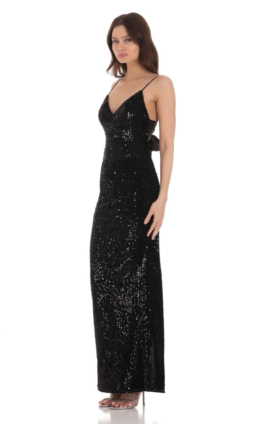 Picture Velvet Sequin Back Bow Maxi Dress in Black. Source: https://media-img.lucyinthesky.com/data/Jan24/850xAUTO/c686b72f-e43e-4dc6-8461-7441c132eefd.jpg