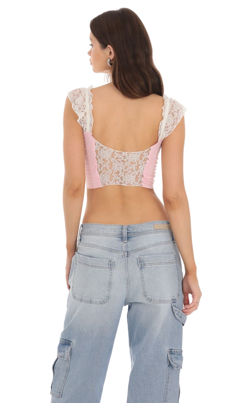 Picture Lace Cutout Top in Pink. Source: https://media-img.lucyinthesky.com/data/Jan24/850xAUTO/eced26e1-f0bb-4e23-8007-fc83b2ae2ff2.jpg