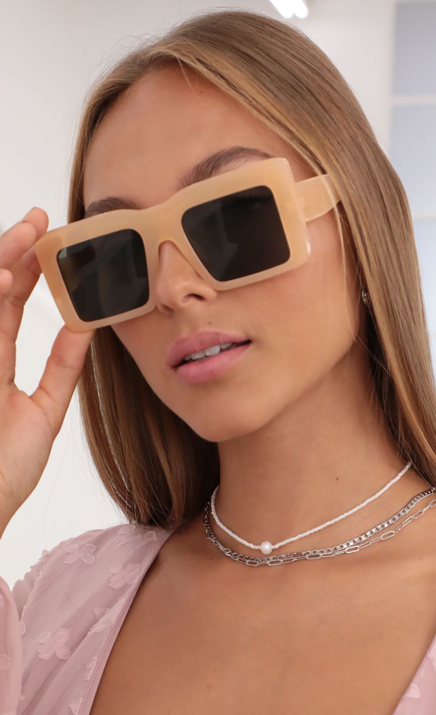 Picture Devany Oversized Square Sunglasses in Nude. Source: https://media-img.lucyinthesky.com/data/Jul21_2/850xAUTO/AT2A7967_COPY.JPG