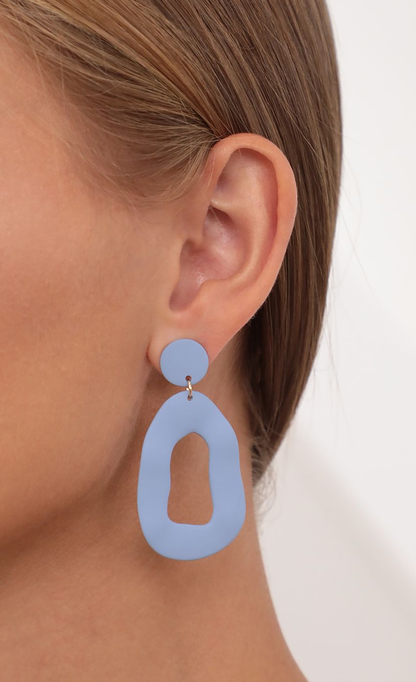 Picture Groovy Baby Silicon Dangle Earrings in Blue. Source: https://media-img.lucyinthesky.com/data/Jul21_2/850xAUTO/AT2A9307.JPG