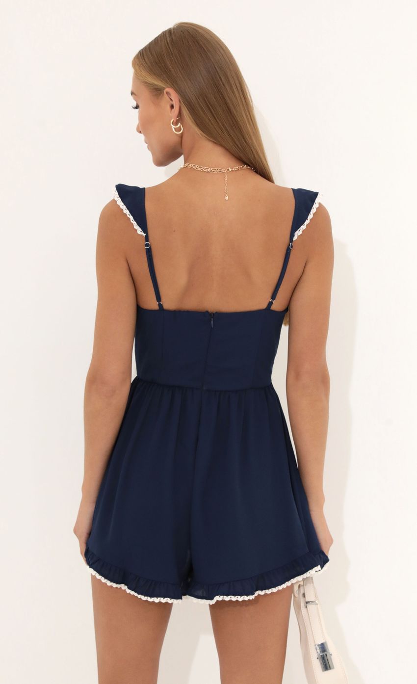 Picture Jane Wooldoby Ruffle Romper in Navy. Source: https://media-img.lucyinthesky.com/data/Jul22_1/850xAUTO/1V9A0115.JPG