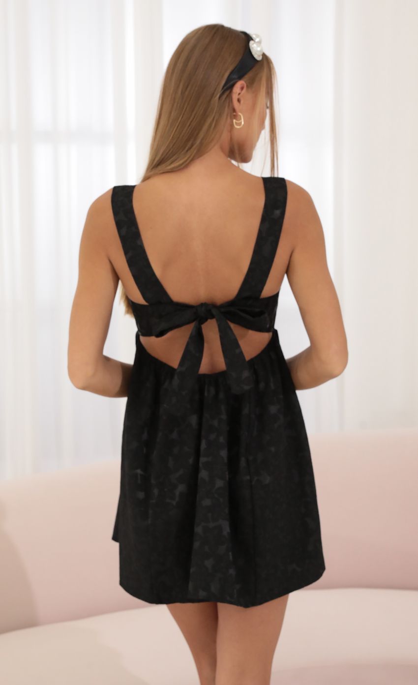 Picture Floral Jacquard Fit and Flare Dress in Black. Source: https://media-img.lucyinthesky.com/data/Jul22_1/850xAUTO/1V9A0552.JPG