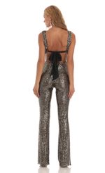 Picture Gold Sequin Back Bow Tie Jumpsuit in Black. Source: https://media-img.lucyinthesky.com/data/Jul23/150xAUTO/1b66abaf-1814-4203-a72f-f4aec43b8987.jpg