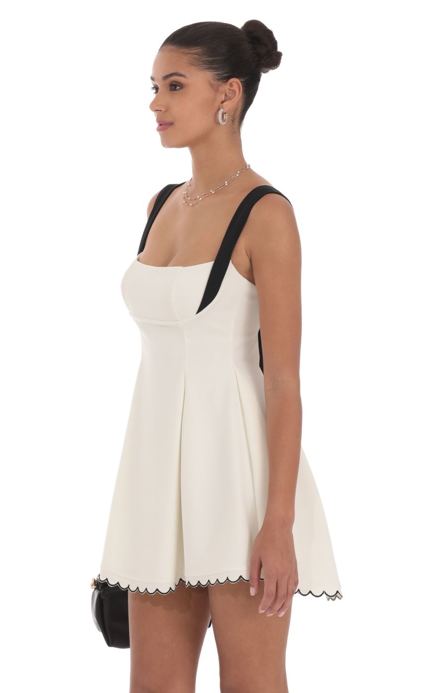 Picture Scallop Hem Fit and Flare Dress in White. Source: https://media-img.lucyinthesky.com/data/Jul24/850xAUTO/2a3e1fdf-1711-4c68-8065-b9428a8fe3c4.jpg