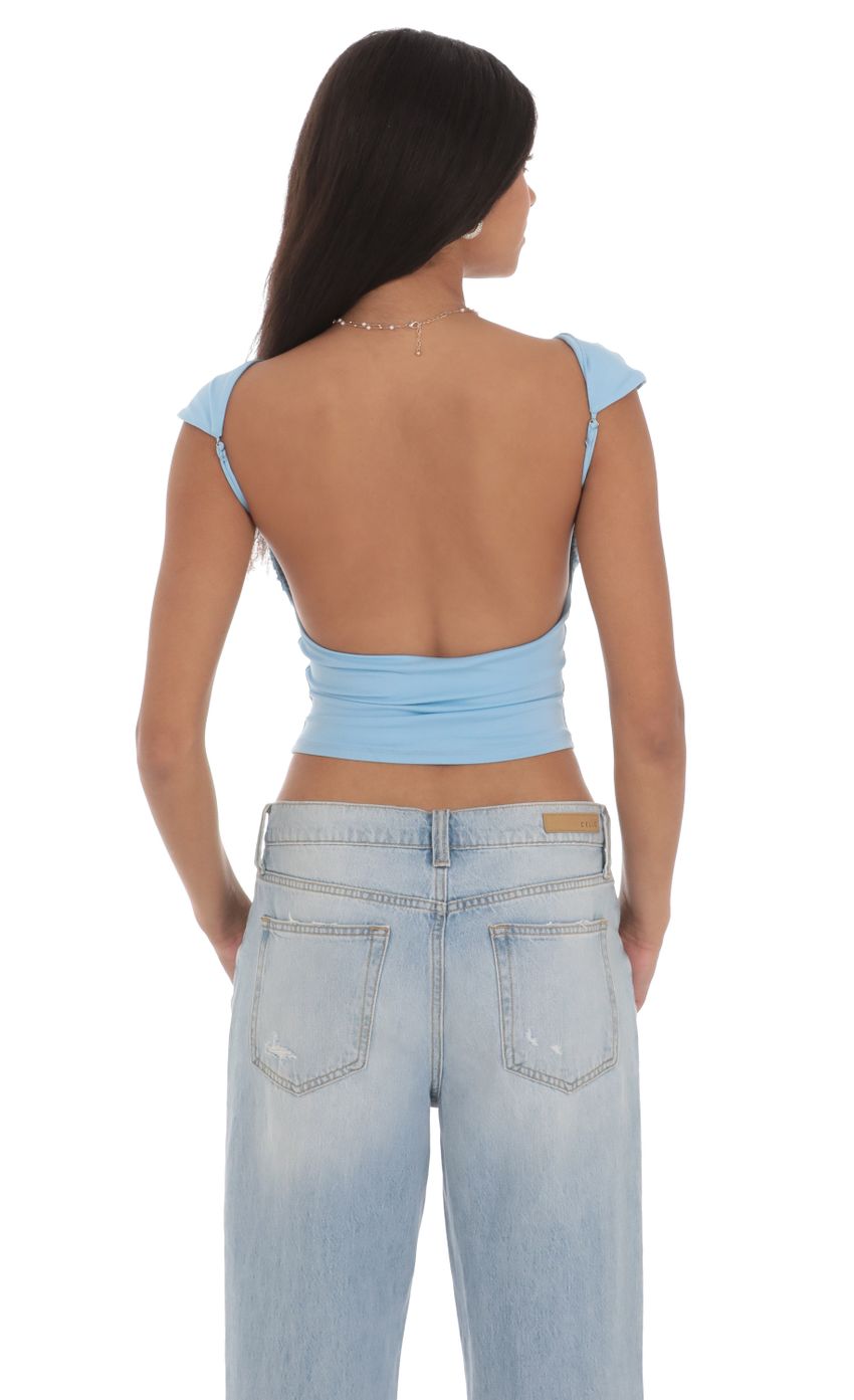 Picture High Neck Open Back Top in Light Blue. Source: https://media-img.lucyinthesky.com/data/Jul24/850xAUTO/3f90b071-e33e-4aa0-ab64-b9e41be2ce12.jpg