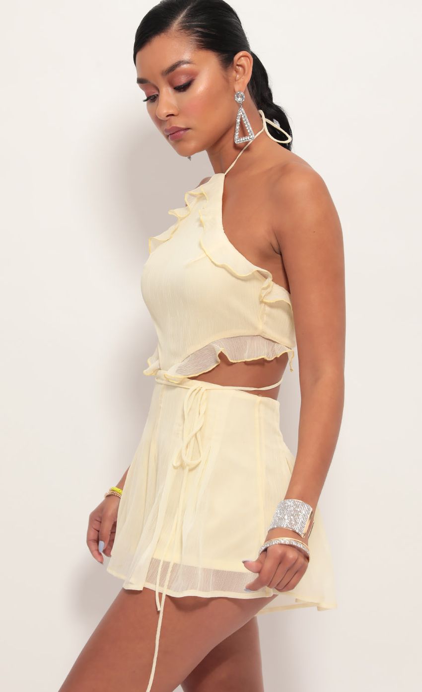 Picture Cutout Halter Romper in Light Yellow. Source: https://media-img.lucyinthesky.com/data/Jun19_2/850xAUTO/781A7259.JPG