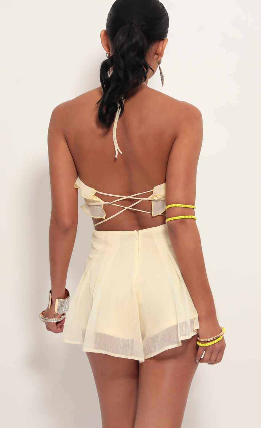 Picture Cutout Halter Romper in Light Yellow. Source: https://media-img.lucyinthesky.com/data/Jun19_2/850xAUTO/781A7280.JPG
