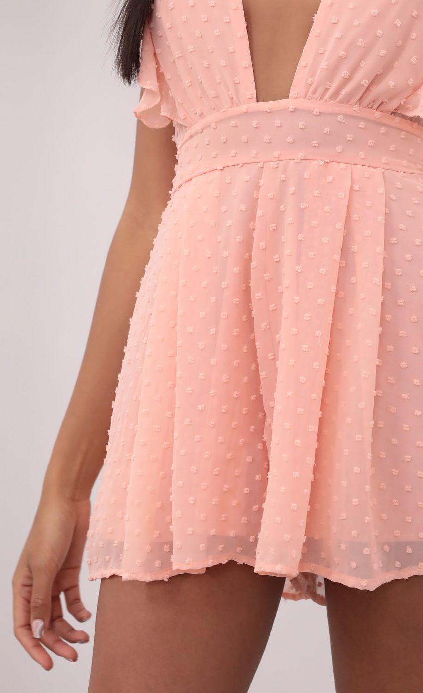 Picture Ruffle Pastel Coral Romper in Dotted Chiffon. Source: https://media-img.lucyinthesky.com/data/Jun21_1/850xAUTO/1V9A2769.JPG