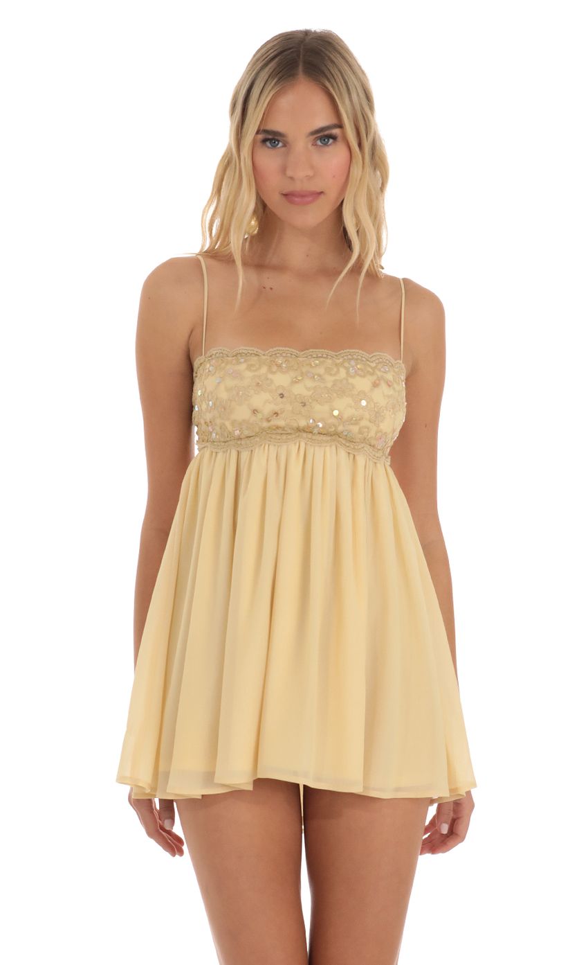Picture Sequin Lace Baby Doll Dress in Gold. Source: https://media-img.lucyinthesky.com/data/Jun23/850xAUTO/4257416e-5d1a-44b4-8d68-9775a1994f86.jpg