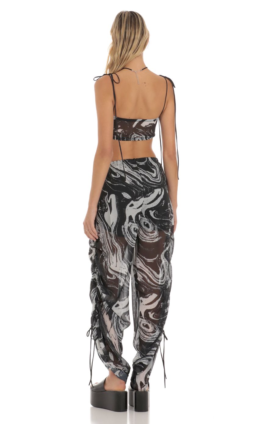Picture Ruched Pant Set in Black Swirl. Source: https://media-img.lucyinthesky.com/data/Jun23/850xAUTO/f8c047f4-7a05-48a7-b273-abdcee190f66.jpg