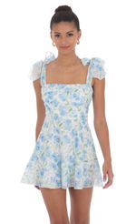 Picture Blue Floral A-line Dress in White. Source: https://media-img.lucyinthesky.com/data/Jun24/150xAUTO/c7c08922-542b-41a6-a41c-6dac972a79d4.jpg