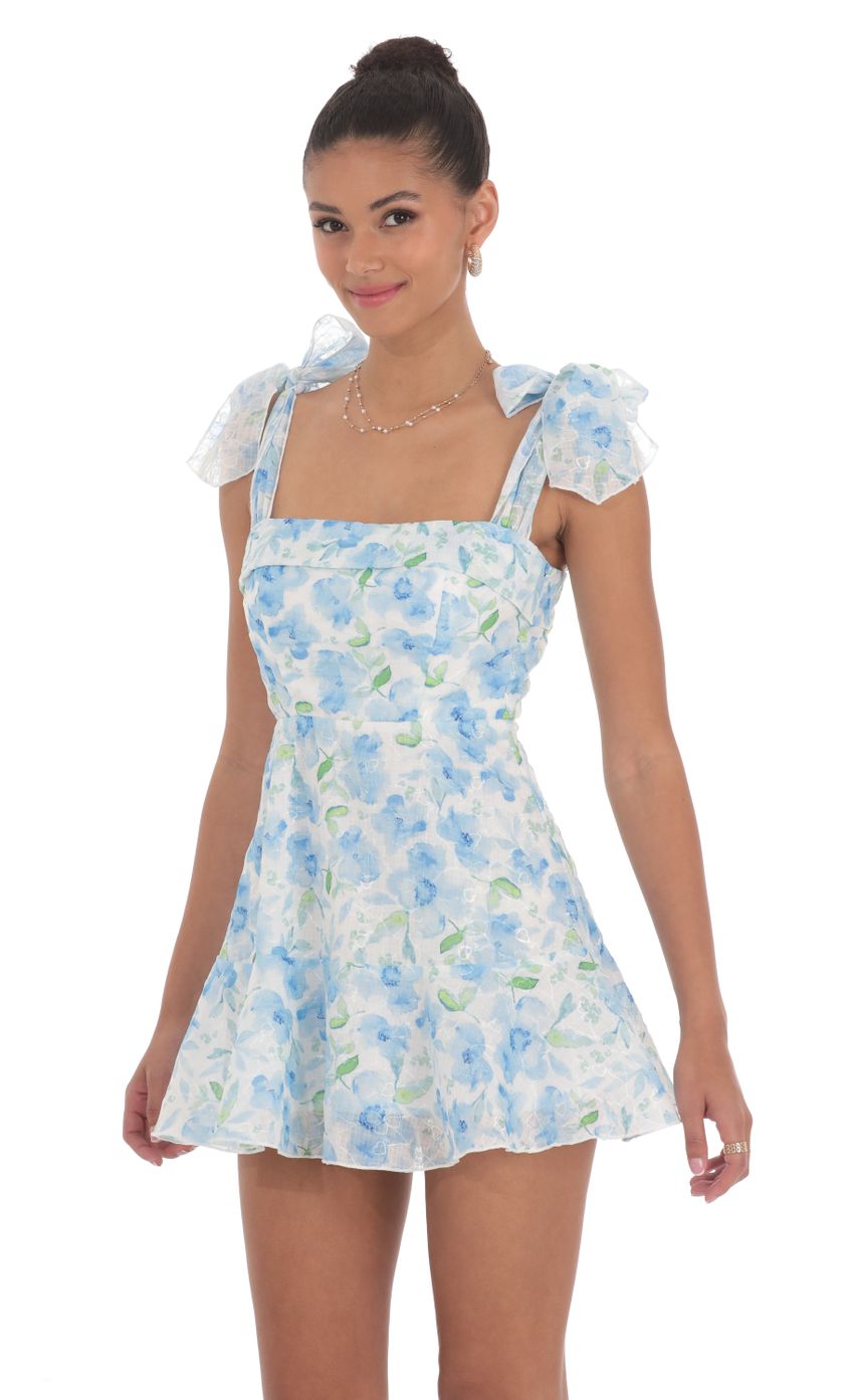 Picture Blue Floral A-line Dress in White. Source: https://media-img.lucyinthesky.com/data/Jun24/850xAUTO/06a2b996-8d59-489f-95c1-a9f40a56bc94.jpg