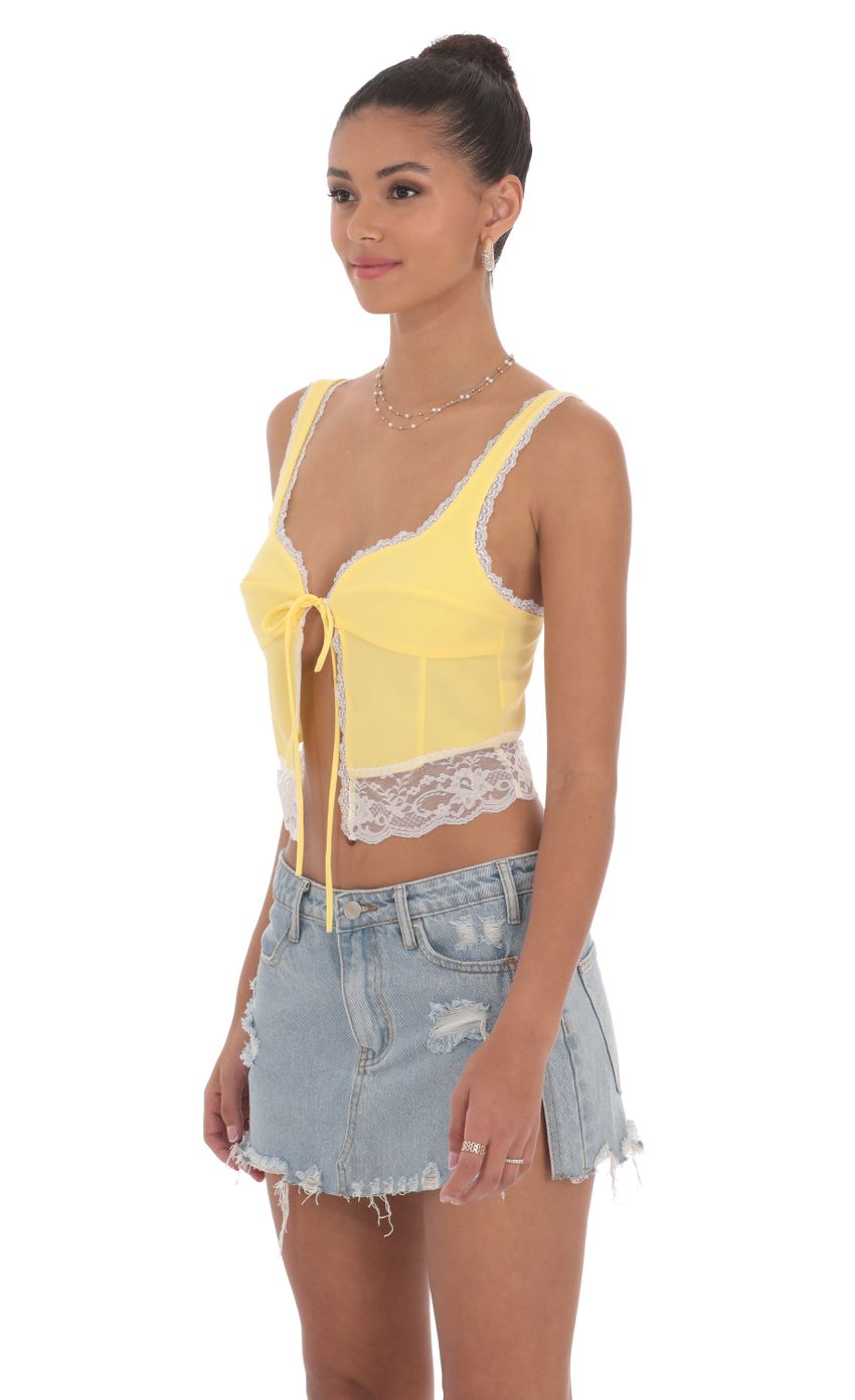 Picture Lace Vest Top in Yellow. Source: https://media-img.lucyinthesky.com/data/Jun24/850xAUTO/c9faa2d6-d36c-4fd1-a3b7-a152499f60f9.jpg