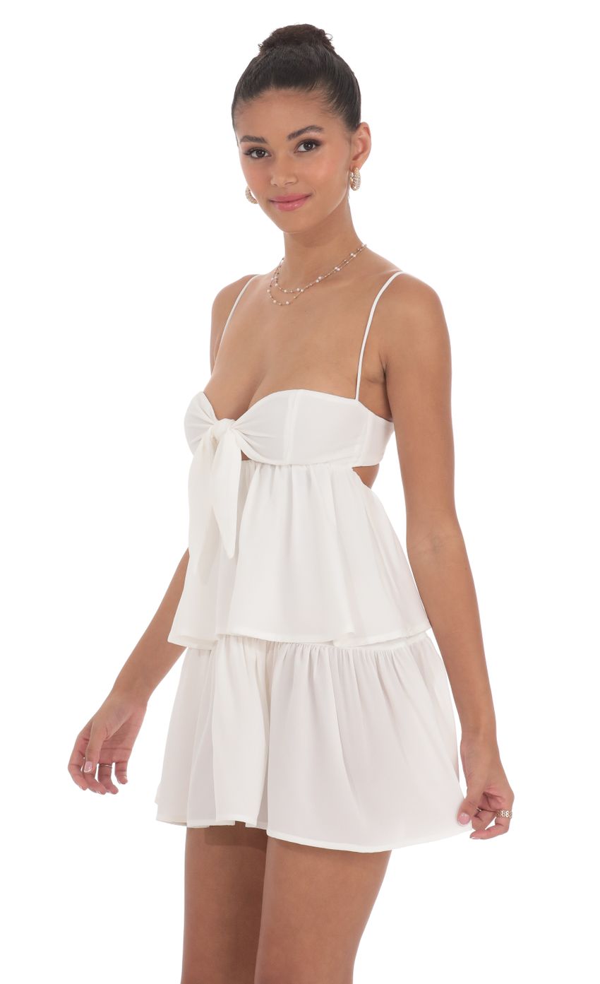 Picture Ruffle Front Tie Dress in White. Source: https://media-img.lucyinthesky.com/data/Jun24/850xAUTO/d6a0ef5f-6415-47f9-ab69-7a3730fc3a8a.jpg