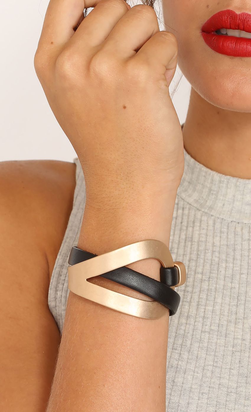Picture Black And Gold Intertwined Bracelet. Source: https://media-img.lucyinthesky.com/data/Mar15_1/850xAUTO/0Y5A8414HALF_LIPS.JPG