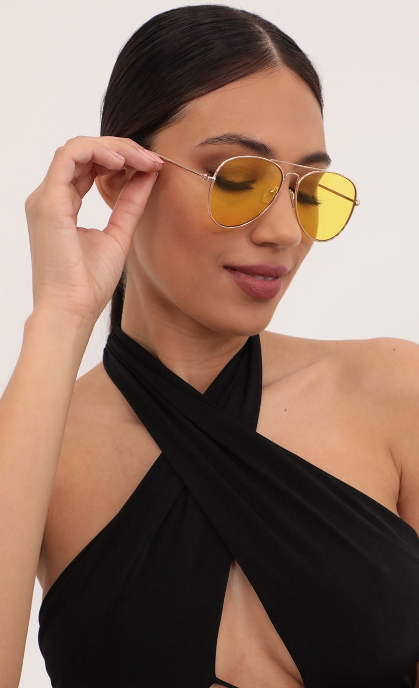 Picture Iconic Retro Aviator Sunglasses in Yellow. Source: https://media-img.lucyinthesky.com/data/Mar21_1/850xAUTO/AT2A0885_COPY.JPG
