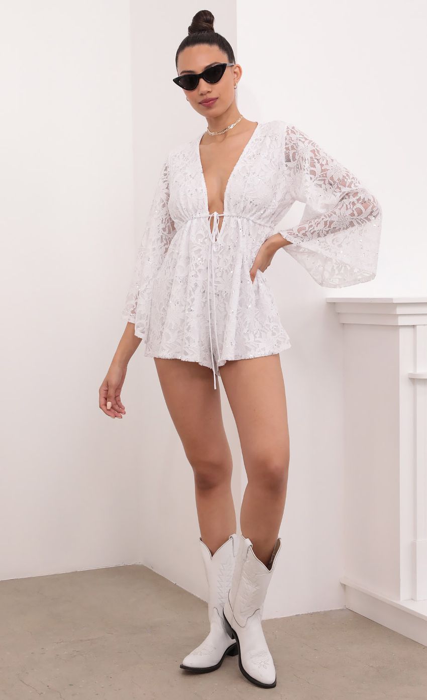 Picture Kadee Bell Sleeve Romper in White Sequined Lace. Source: https://media-img.lucyinthesky.com/data/Mar21_2/850xAUTO/1V9A5483.JPG