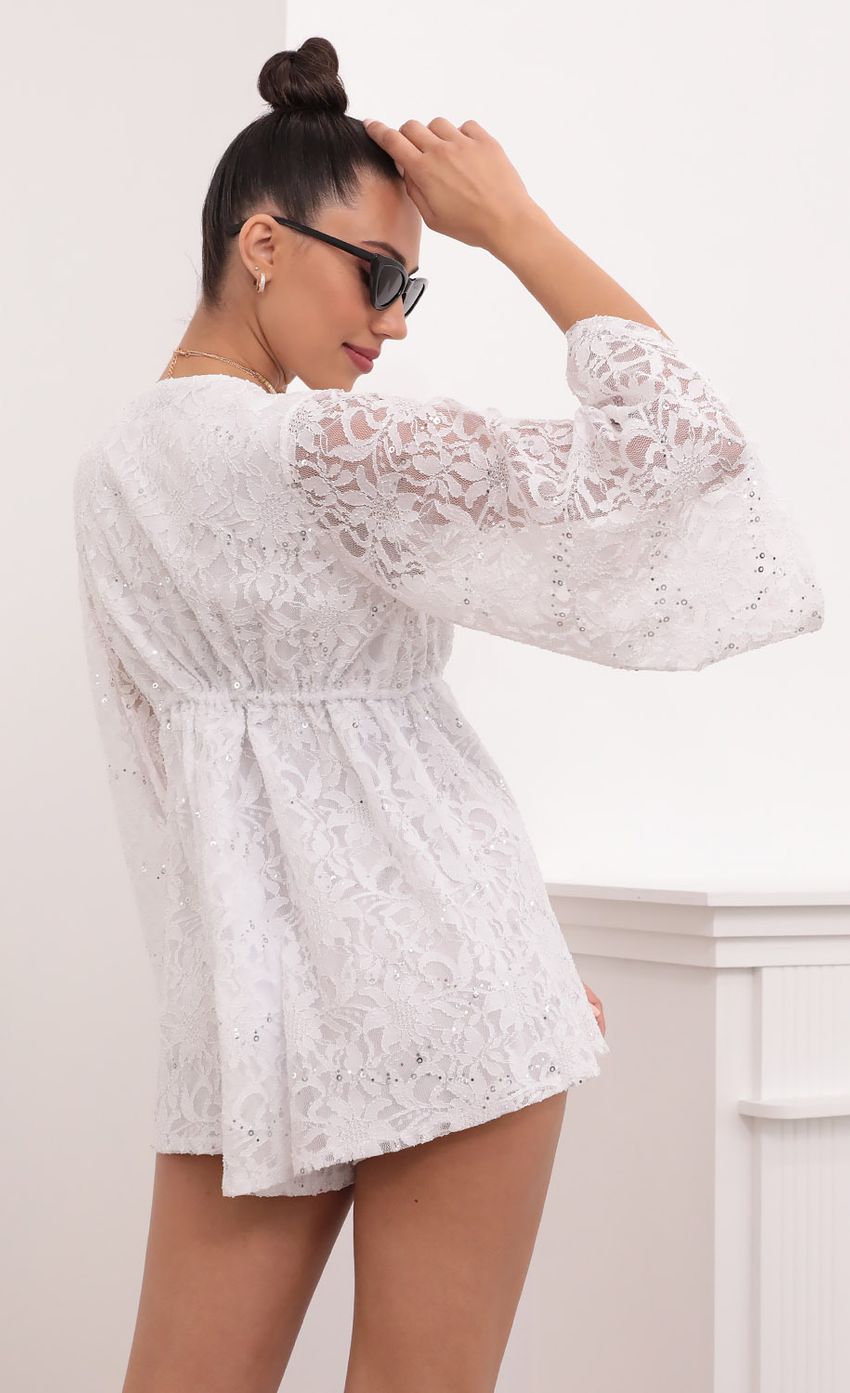 Picture Kadee Bell Sleeve Romper in White Sequined Lace. Source: https://media-img.lucyinthesky.com/data/Mar21_2/850xAUTO/1V9A5613.JPG